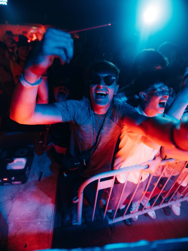 Crowd cheering at the front barrier with bright lights and energy during the House of Tech event in Ayia Napa.