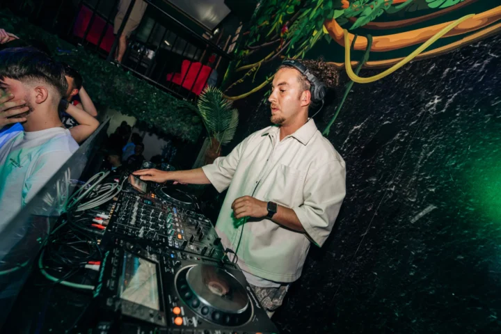 DJ spinning house beats at Club Tropicana Albufeira as the crowd goes off under tropical lights and summer party vibes.