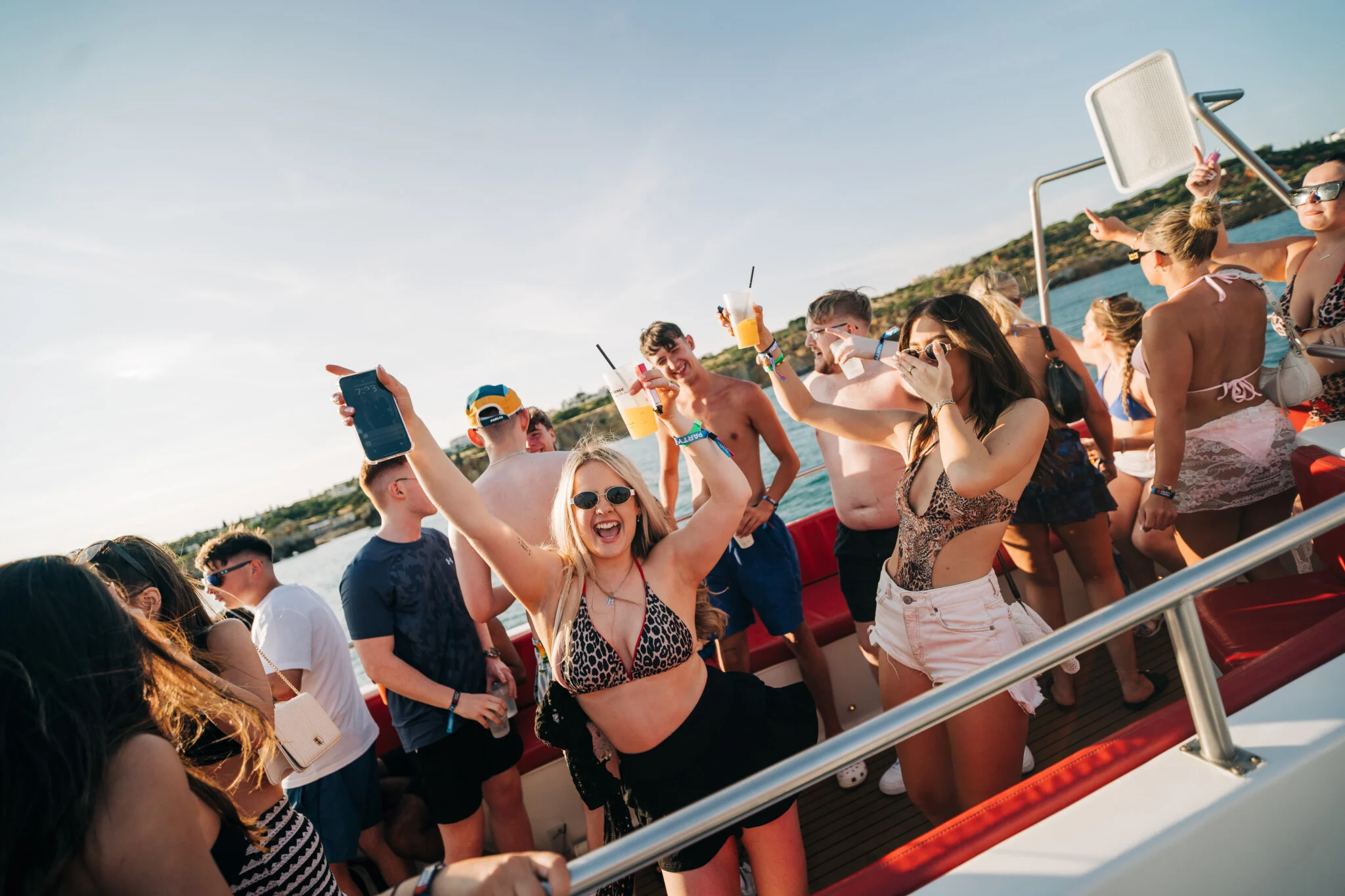 Girls and lads partying with drinks on the Albufeira Boat Party in Albufeira.