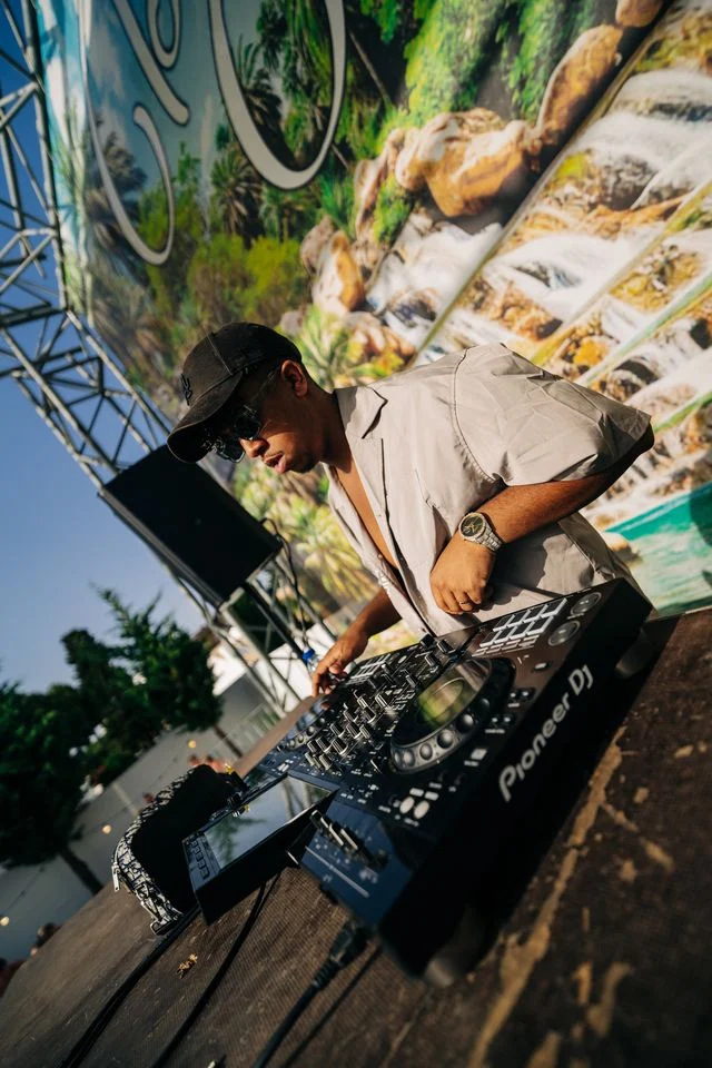 DJ bringing the heat at the Albufeira Pool Party, spinning summer anthems as the crowd vibes under the sun.
