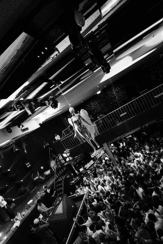 Crowd packed into Club Heaven Albufeira as DJs drop tracks beneath the club’s iconic silver angel and party lights.