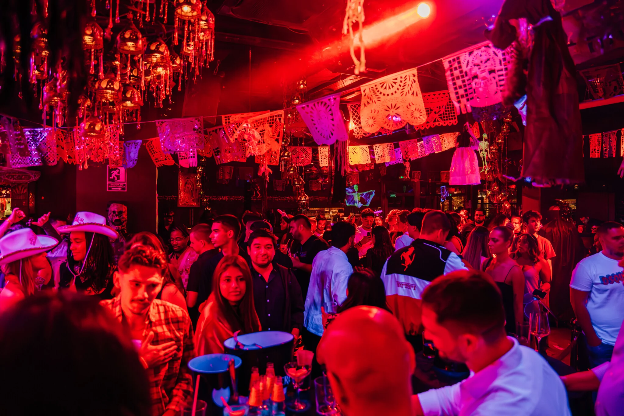 Packed night at CDLC Carpe Diem Barcelona with lads and girls filling the dancefloor under neon lights, fiesta décor and big party energy.